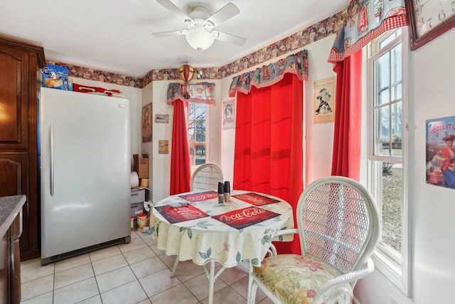 dining space with ceiling fan and light tile patterned floors