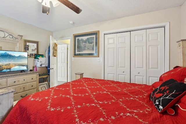 bedroom with ceiling fan, a closet, and a textured ceiling