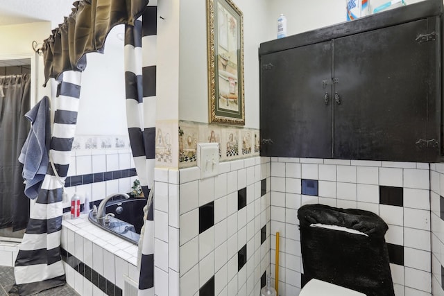 bathroom with a relaxing tiled tub and tile walls