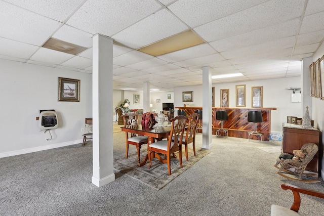 dining room featuring carpet, heating unit, bar, and a drop ceiling