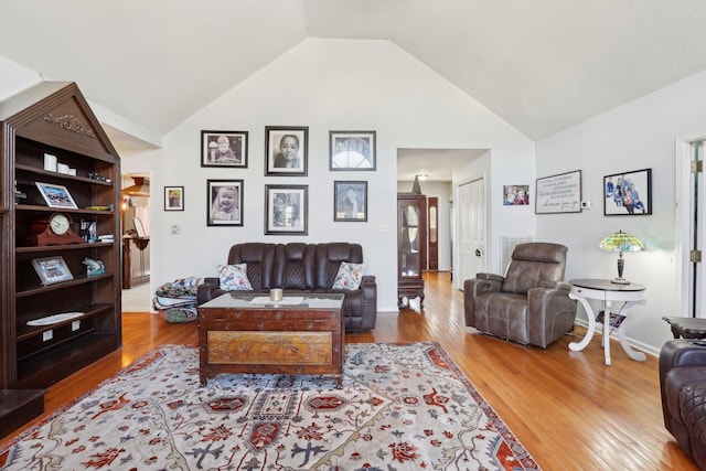 living room featuring hardwood / wood-style floors and high vaulted ceiling