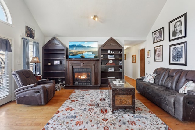 living room with light hardwood / wood-style flooring and high vaulted ceiling