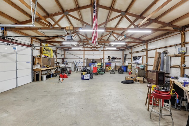 garage with a garage door opener and a workshop area