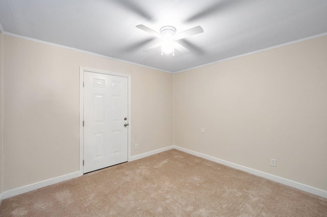 empty room with light carpet, ceiling fan, baseboards, and crown molding