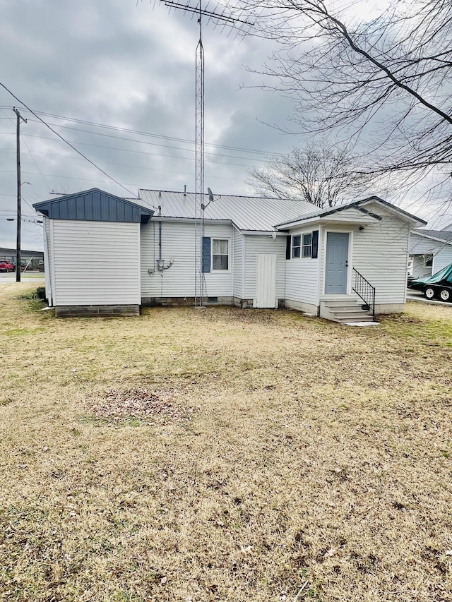 rear view of house with a lawn