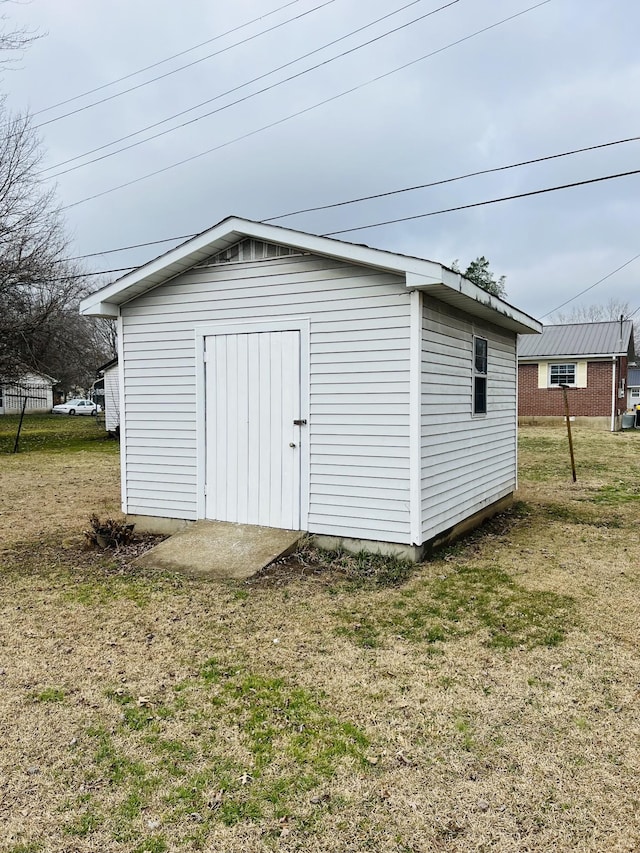 view of outbuilding with a yard