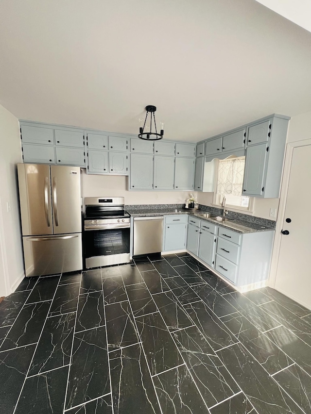 kitchen featuring stainless steel appliances, sink, and gray cabinetry