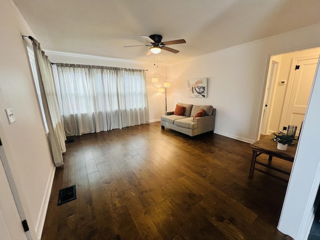 living room with ceiling fan and dark hardwood / wood-style flooring