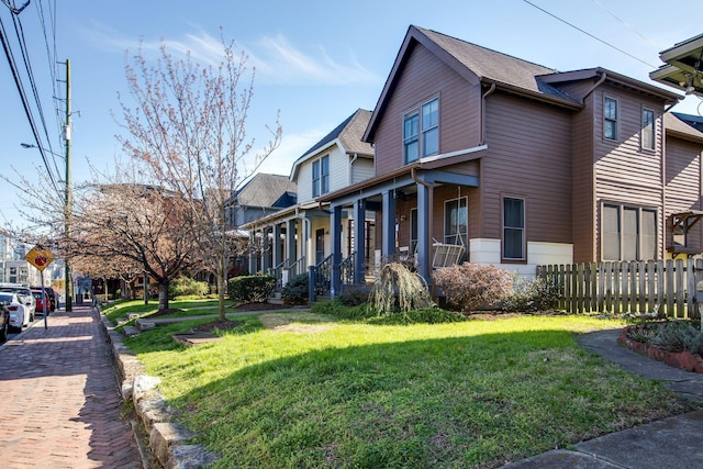 view of side of property with a porch and a yard