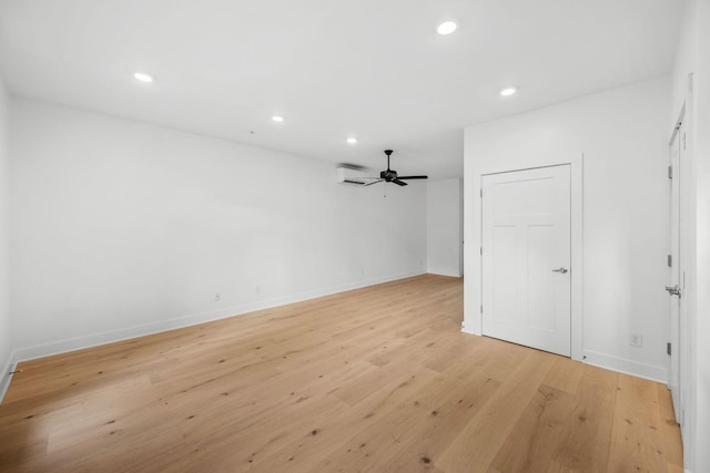 unfurnished room with ceiling fan and light hardwood / wood-style flooring