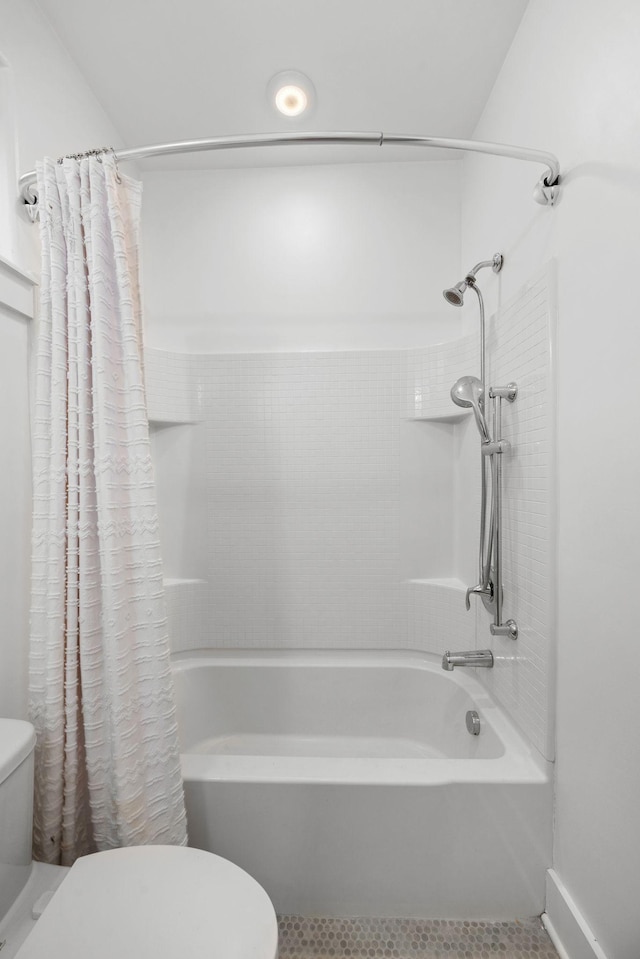 bathroom with toilet and shower / bath combo with shower curtain