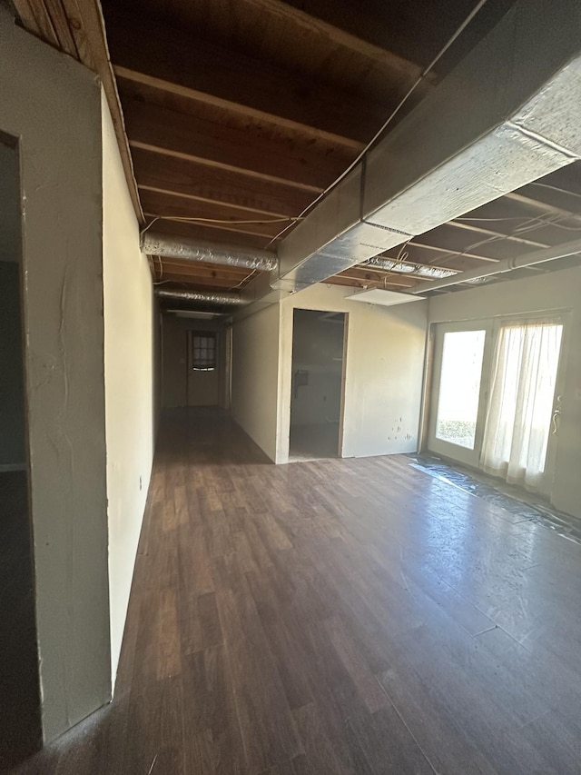 basement with dark hardwood / wood-style floors