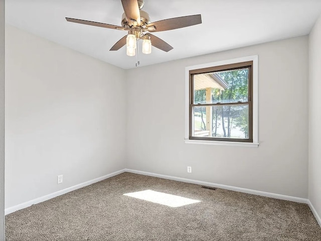 carpeted empty room featuring ceiling fan