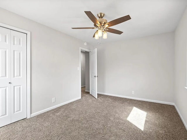 unfurnished bedroom featuring carpet floors, ceiling fan, and a closet