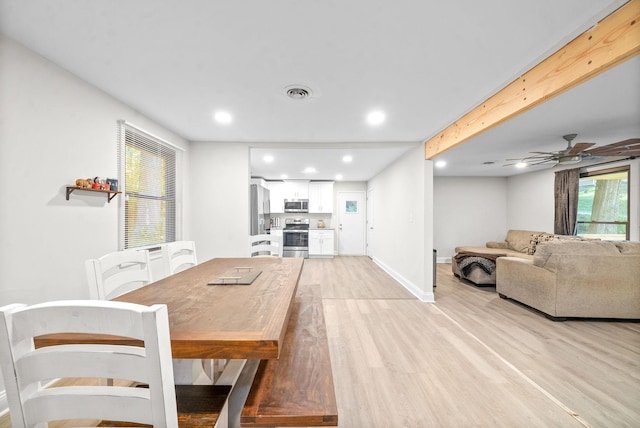 dining space with light wood-type flooring