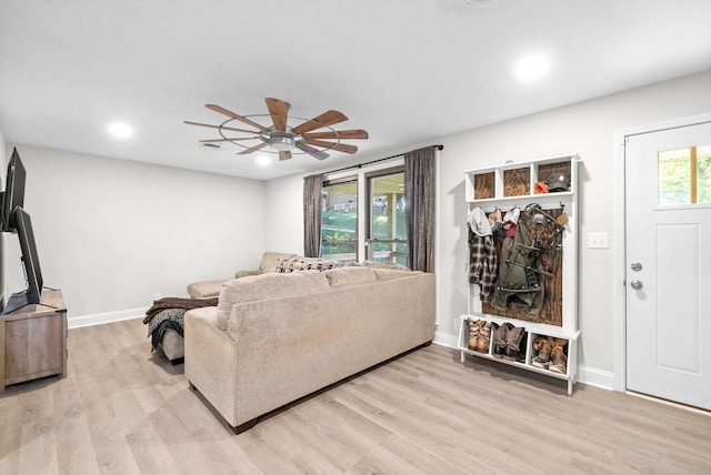 living room with ceiling fan and light hardwood / wood-style floors