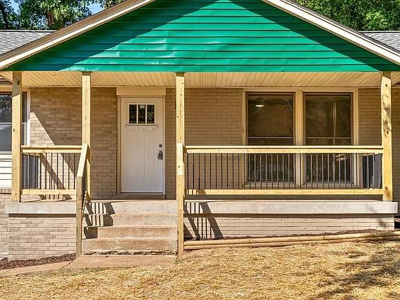 view of exterior entry with a porch