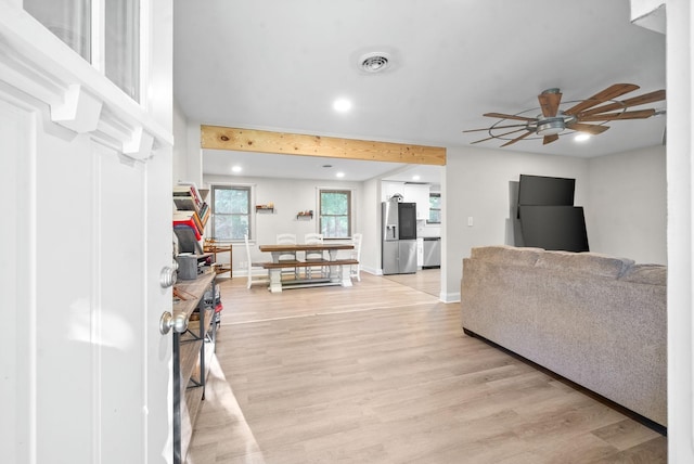 living room featuring light hardwood / wood-style flooring and ceiling fan