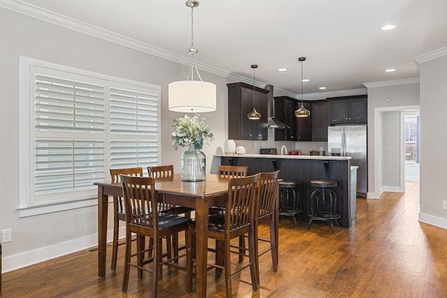 dining room with ornamental molding and dark hardwood / wood-style floors