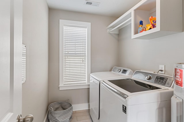 clothes washing area with independent washer and dryer