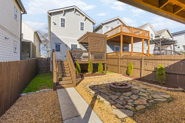 rear view of house featuring a pergola, a deck, and an outdoor fire pit