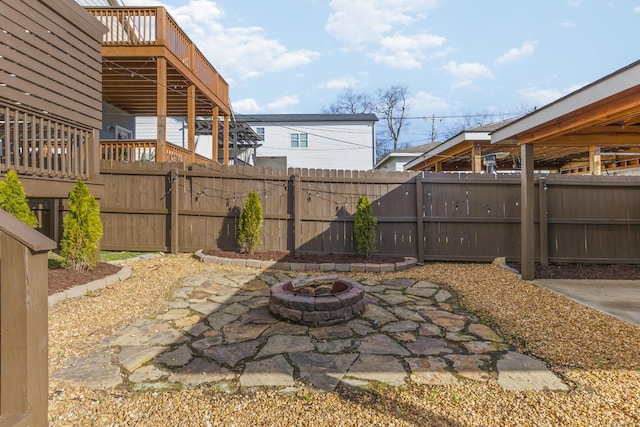 view of patio / terrace with a fire pit and a deck