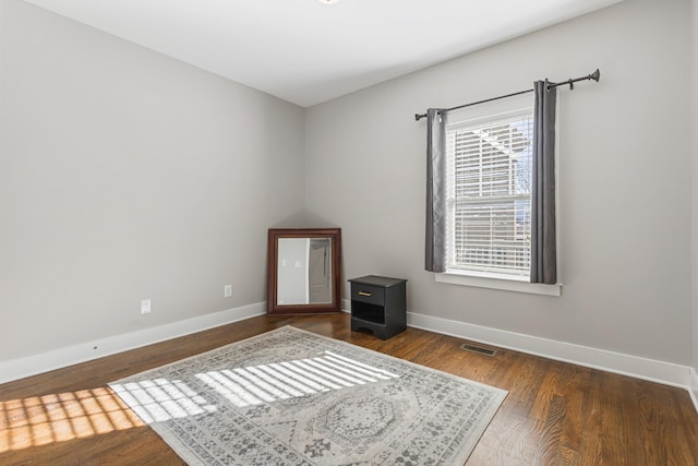 unfurnished room featuring dark wood-type flooring