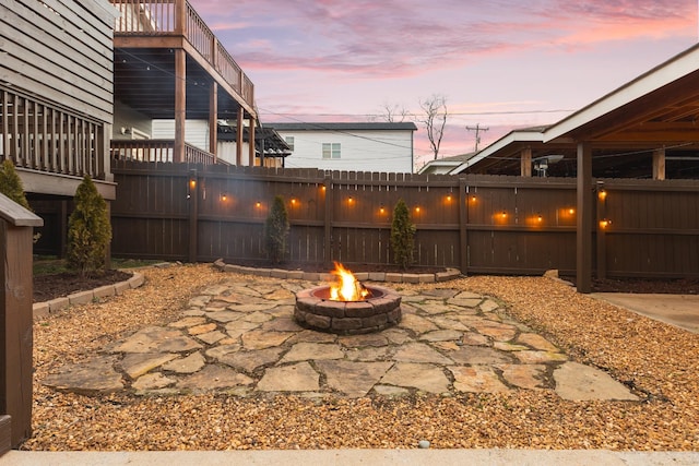 patio terrace at dusk featuring a fire pit