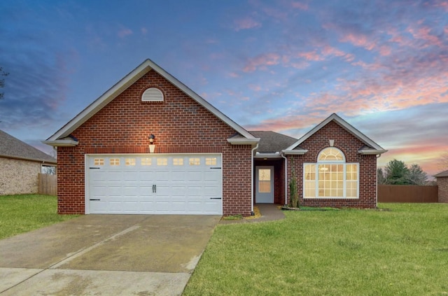 view of front of property featuring a garage and a lawn