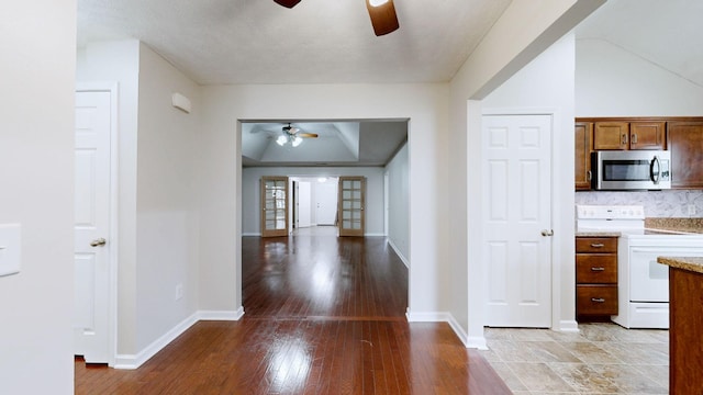 interior space featuring wood-type flooring, white electric range oven, and ceiling fan