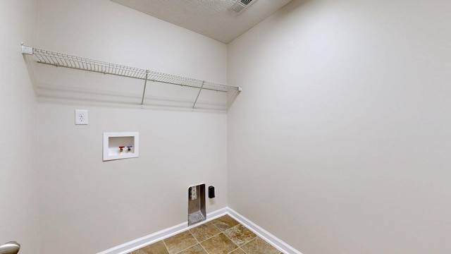 laundry area featuring hookup for a washing machine and a textured ceiling