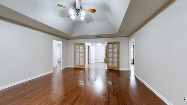 unfurnished room with lofted ceiling, dark wood-type flooring, ceiling fan, and french doors