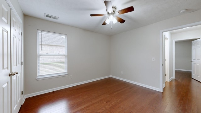 unfurnished bedroom with dark wood-type flooring and ceiling fan