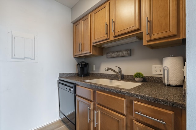 kitchen featuring dishwasher, sink, electric panel, and dark stone counters