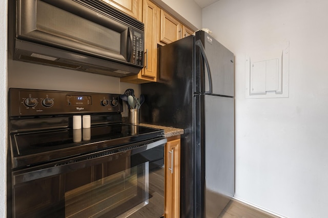 kitchen featuring light brown cabinets and black appliances