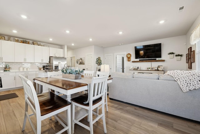 dining area with light hardwood / wood-style flooring