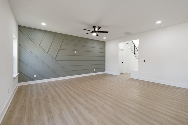 spare room with ceiling fan and light wood-type flooring