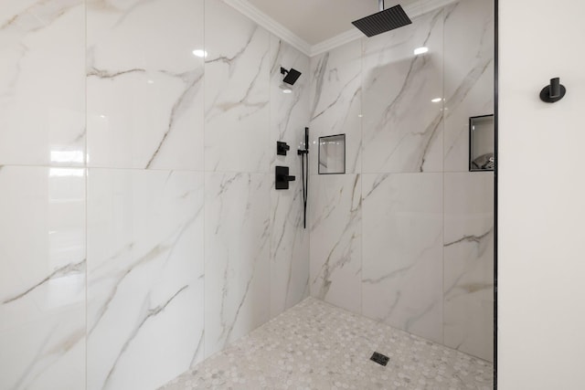 bathroom with crown molding and tiled shower