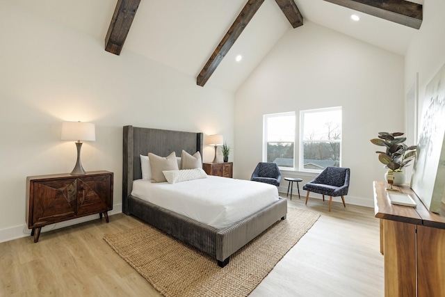 bedroom with beam ceiling, high vaulted ceiling, and light wood-type flooring