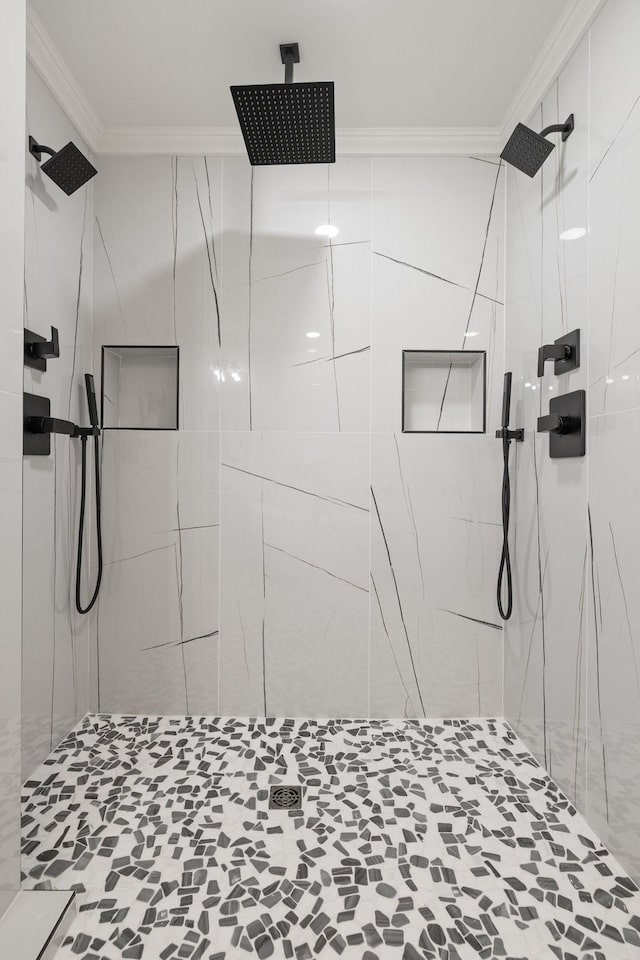 bathroom featuring ornamental molding and a tile shower