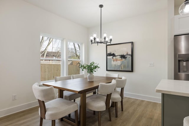 dining space with wood-type flooring