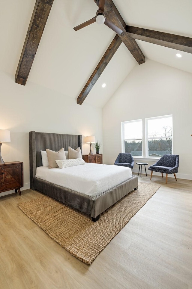 bedroom with beamed ceiling, ceiling fan, wood-type flooring, and high vaulted ceiling