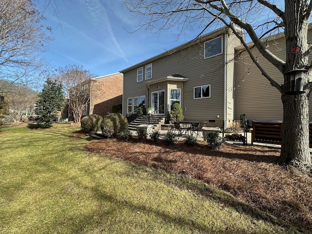 rear view of house featuring a yard and a patio area