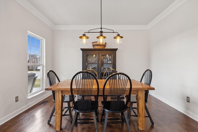 dining space featuring crown molding and dark hardwood / wood-style floors