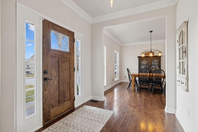 foyer featuring crown molding and dark hardwood / wood-style flooring