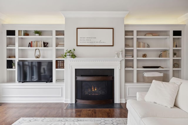 living room with crown molding and dark wood-type flooring