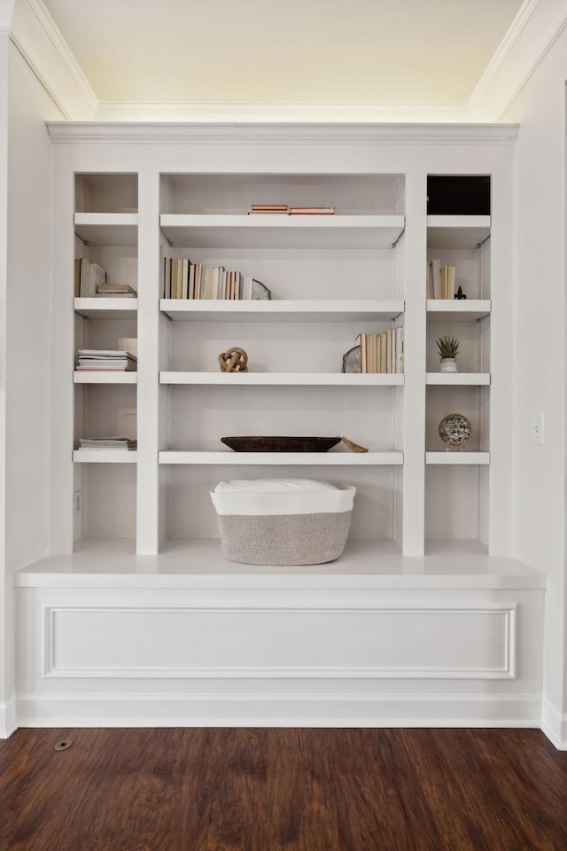 room details featuring crown molding, hardwood / wood-style floors, and built in shelves