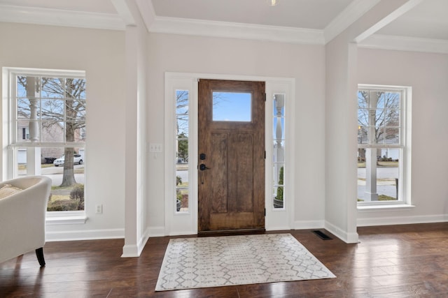 foyer with crown molding, plenty of natural light, and dark hardwood / wood-style floors