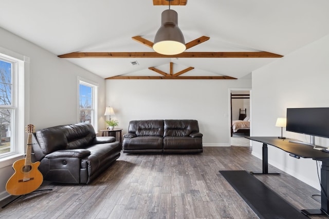 living room with dark hardwood / wood-style flooring and lofted ceiling with beams