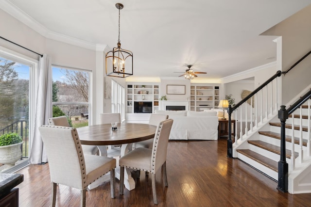 dining space featuring dark hardwood / wood-style flooring, ceiling fan with notable chandelier, and ornamental molding